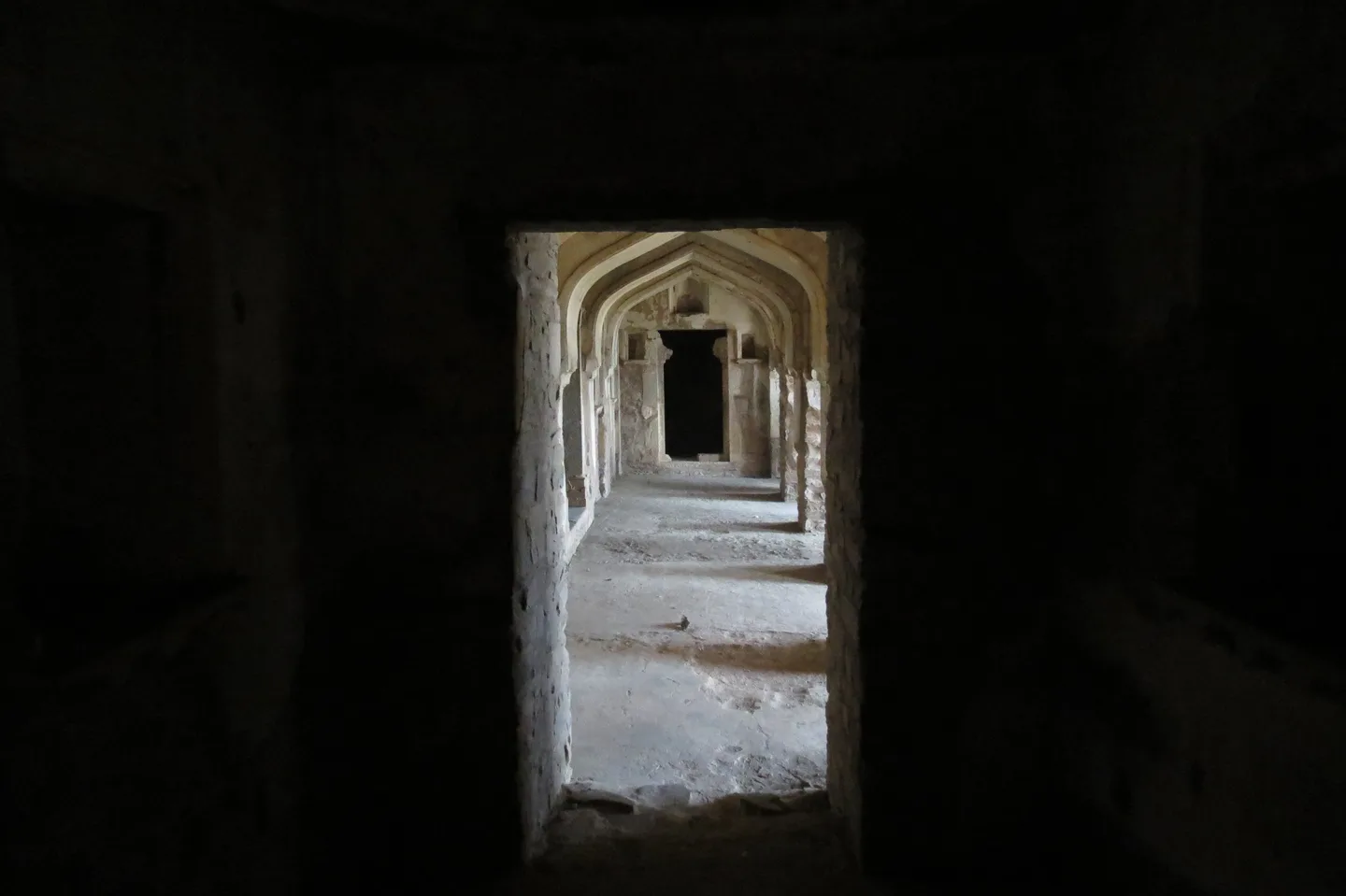 A sequence of stone arches inside Bhangarh Fort